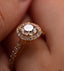 Close-up of a gold ring called with a diamond called 'Parasol' on a finger.
