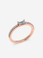 Top view of the Petite Baguette ring in 18K rose gold with a baguette lab-diamond and pave diamond band.