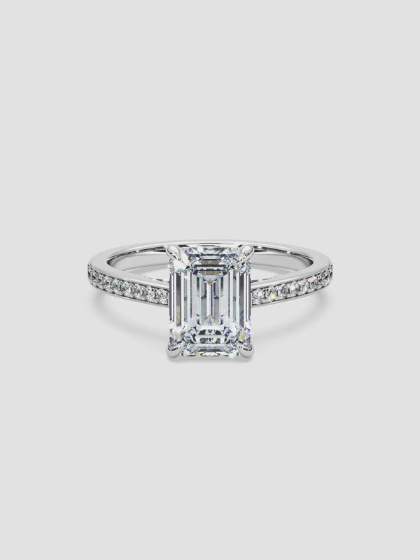 3D video of the Lumiere ring displaying the stunning emerald-cut diamond surrounded by pavé diamonds in an 18k white gold band.