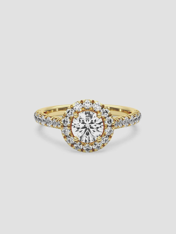 video of the Parasol ring highlighting the round-cut center diamond encircled by a halo of smaller diamonds on an 18k yellow gold band.