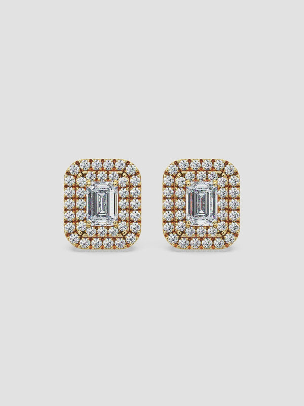 Video of La Perle earrings in 18k yellow gold featuring a luxurious halo of diamonds around a central emerald-cut diamond.